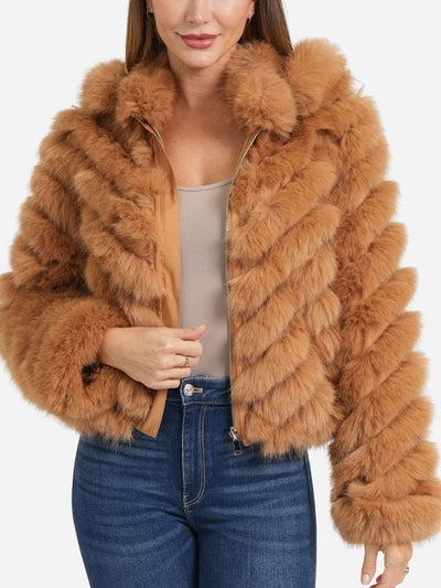 Woman wearing a brown faux fur jacket on a white background