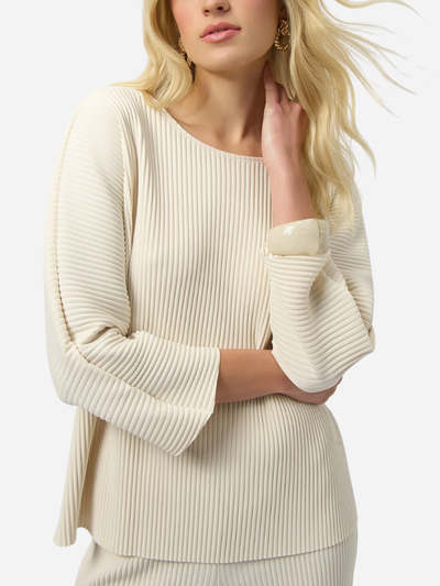 Woman wearing a cream ribbed sweater on a white background