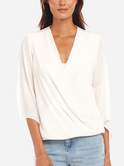 woman in silky white drape front blouse