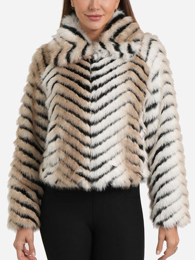 Woman wearing a chevron-patterned faux fur jacket on a white background