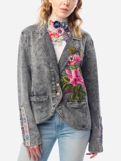 Gray denim jacket with floral embroidery worn by a person on a white background