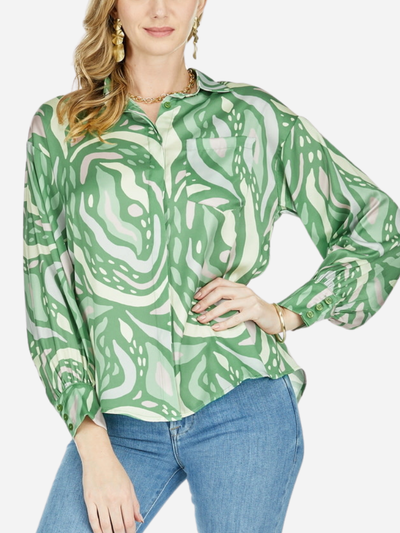 woman in satin green swirl button down top