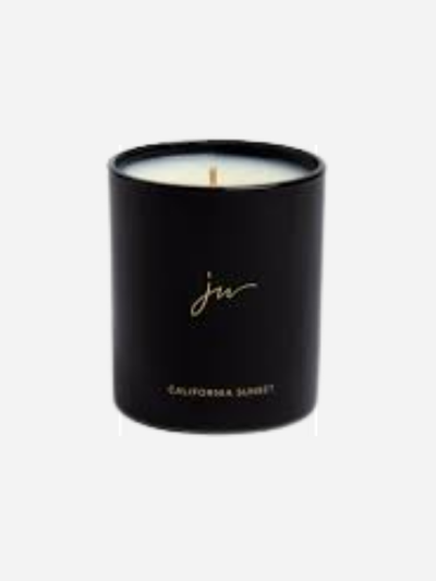 Black candle with Johnny Was logo on a white background