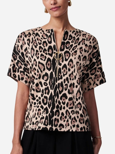 Leopard print top worn by a person on a white background