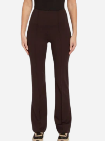 Brown pants worn by a person on a white background