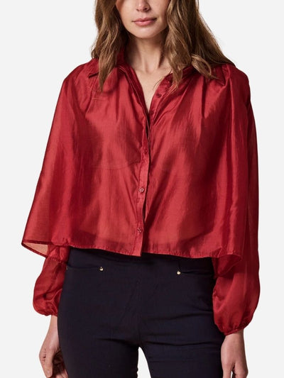 Red blouse worn by a woman on a white background
