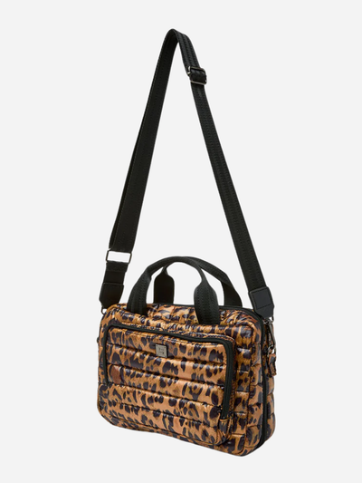 Leopard print toiletry travel bag with a black strap on a light gray background