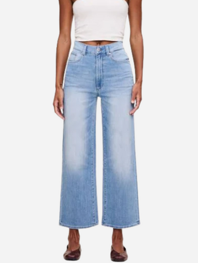 Person wearing light blue wide-leg cropped jeans on a white background