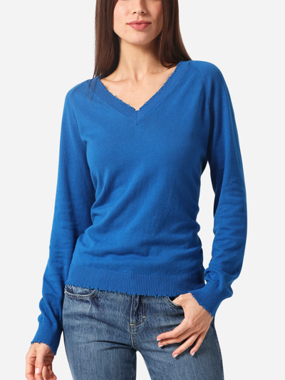 Woman wearing a blue sweater and jeans on a white background
