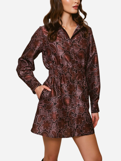 Woman wearing a brown patterned dress on a white background
