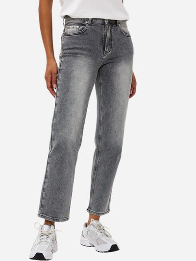 Person wearing gray jeans and white sneakers on a white background