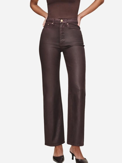 Brown leather pants worn by a woman on a white background