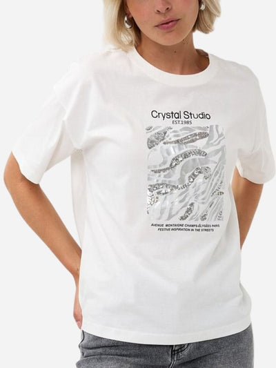 Person wearing a white t-shirt with 'Crystal Studio' design