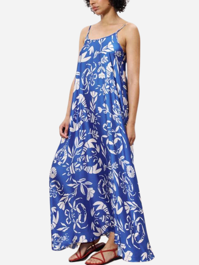 woman in blue maxi dress with white tropical print