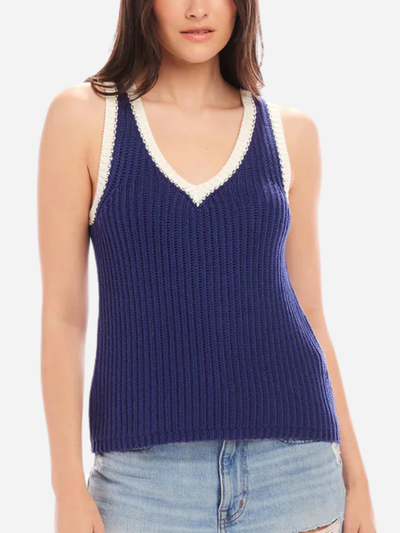 woman in blue sweater tank with white trim