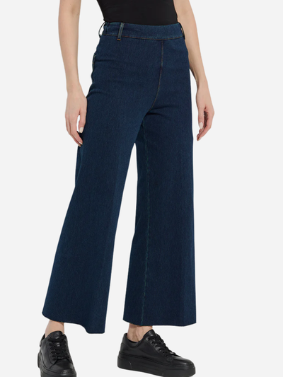 Person wearing dark blue jeans on a white background