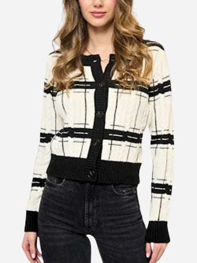 Woman wearing a black and white checkered cardigan with a plain background