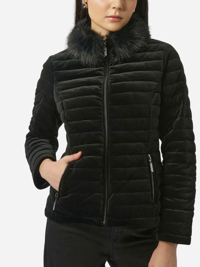 Black quilted puffer jacket with fur collar worn by a woman on a white background