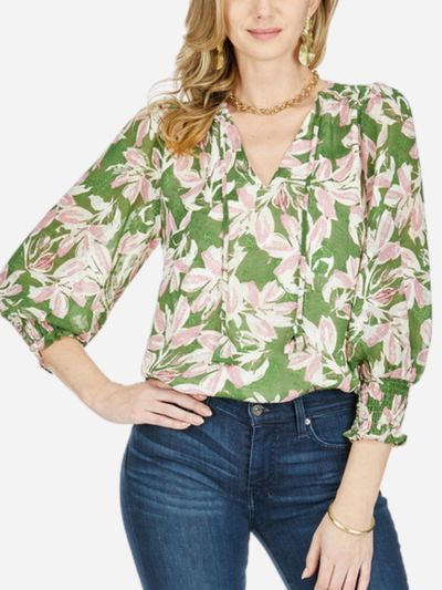 woman in green blouse with pink floral pattern