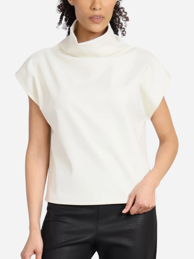 Woman wearing a white sleeveless top with a high collar against a white background