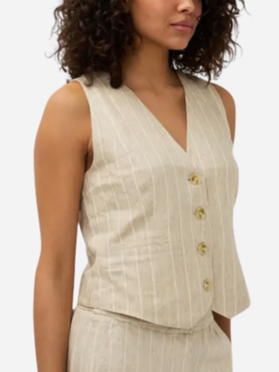 woman in brown linen vest with white stripes