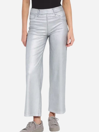 Woman wearing light gray metallic pants on a white background