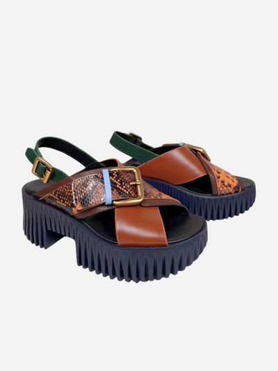 Pair of multicolored brown and animal print sandals with platform sole on a white background