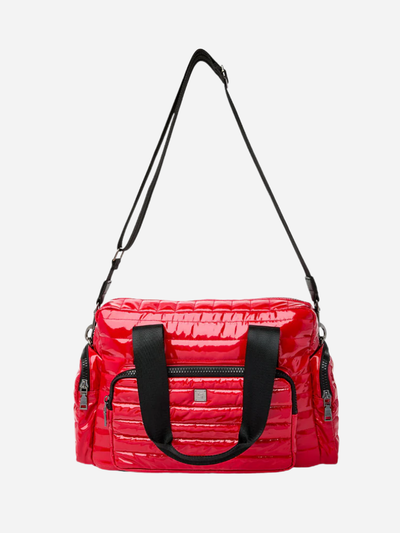 red quilted travel bag with black handles