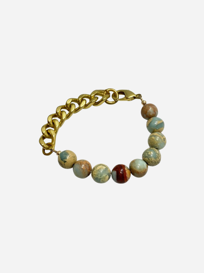Bracelet with gold chain and multicolored beads on a white background
