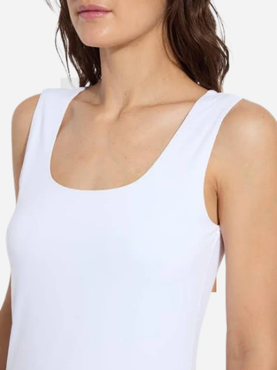 White tank top worn by a person on a white background