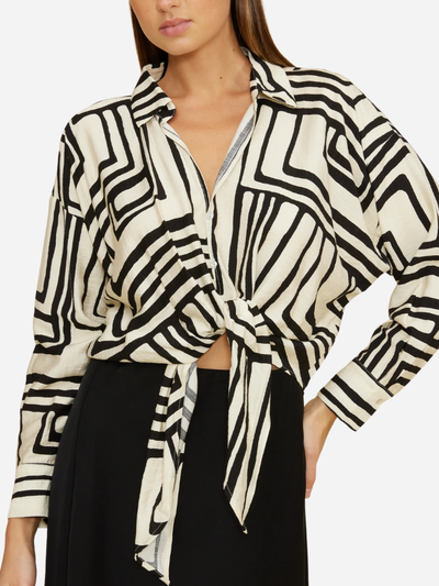 Woman wearing a black and white patterned shirt with a tie waist