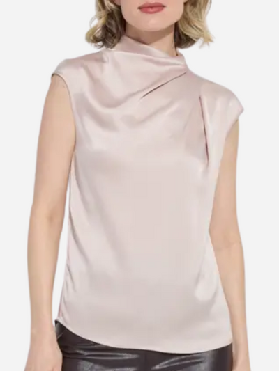 Woman wearing a light pink sleeveless top with a plain background