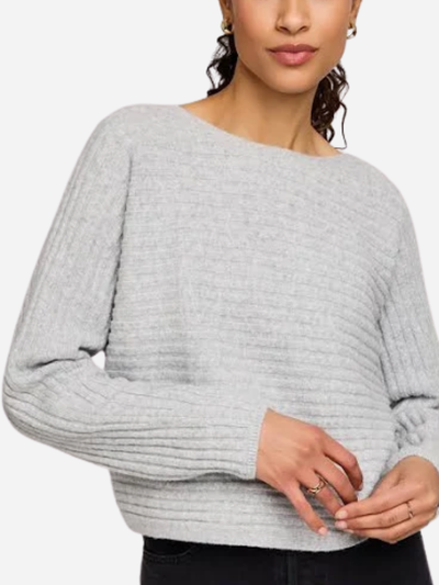 Woman wearing a gray sweater on a white background