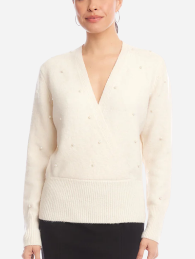 woman in cream wrap sweater with pearl embellishments
