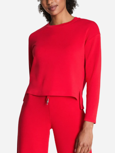 Person wearing a red outfit with a plain background