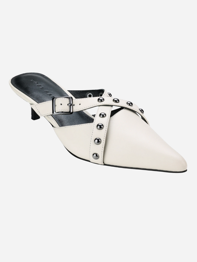 White pointed-toe mule with studded details on a white background