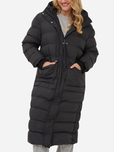 Woman wearing a black puffer coat on a white background
