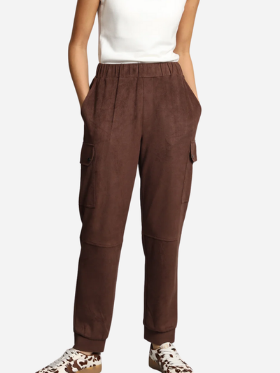 Brown cargo pants worn by a person on a white background