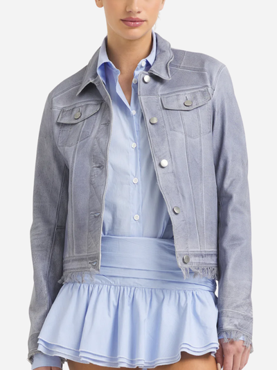 Person wearing a light blue leather jacket over a matching shirt and skirt on a white background