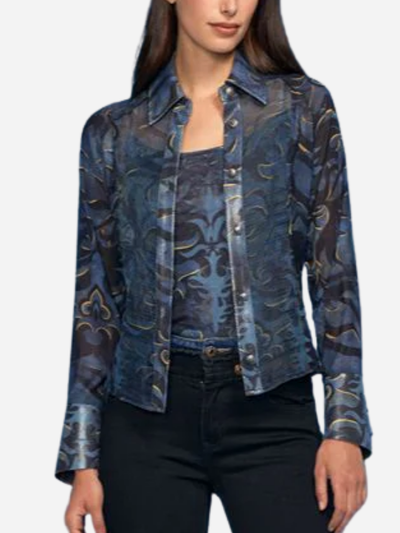 Woman wearing a blue patterned jacket over a black top on a white background