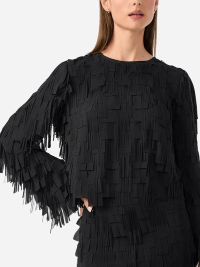 Black fringe dress worn by a model on a white background