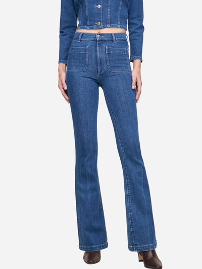 Blue jeans worn by a person on a white background