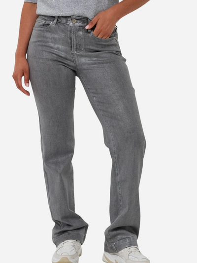 Woman wearing gray metallic jeans on a white background