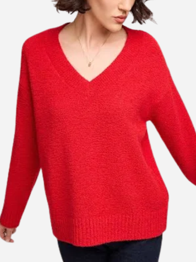 Red v-neck sweater worn by a person on a white background