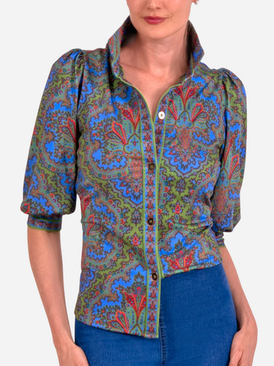 Woman wearing a colorful patterned paisley top on a white background