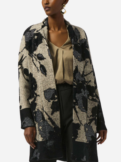 Woman wearing a floral-patterned cardigan on a white background