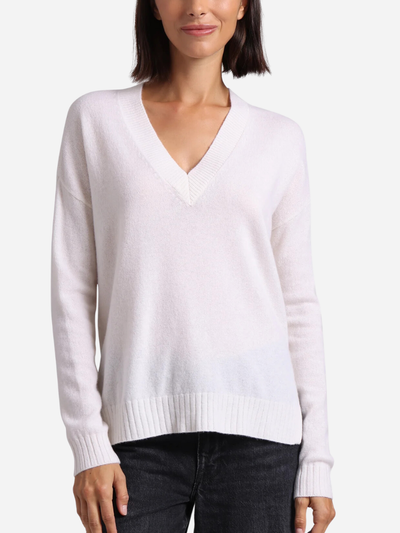 woman in a white v-neck cashmere sweater