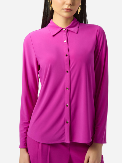 Person wearing a bright pink shirt with a white background