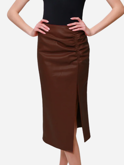 Brown leather skirt worn by a person on a white background