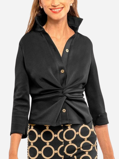 Woman wearing a black top with a knot detail and patterned pants on a white background